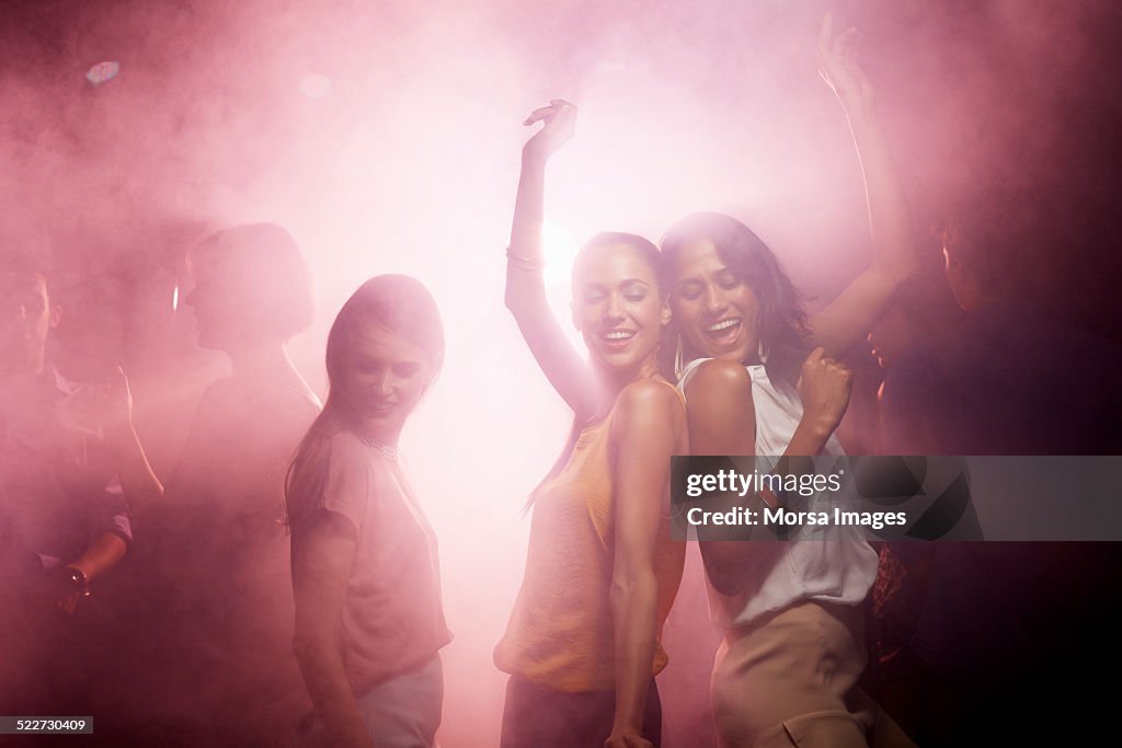 Excited friends enjoying at nightclub