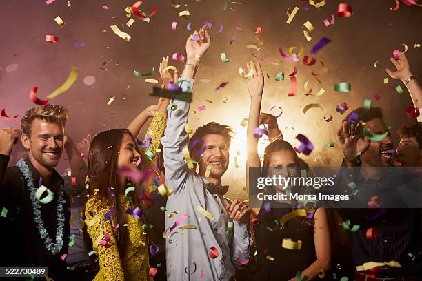 cheerful friends enjoying on dance floor - nightclub foto e immagini stock