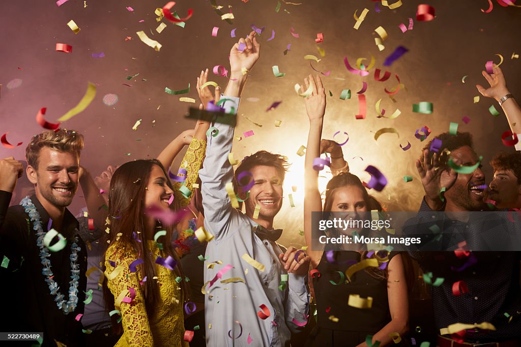 Cheerful friends enjoying on dance floor