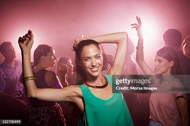 glamorous woman dancing at nightclub - maglietta senza maniche foto e immagini stock