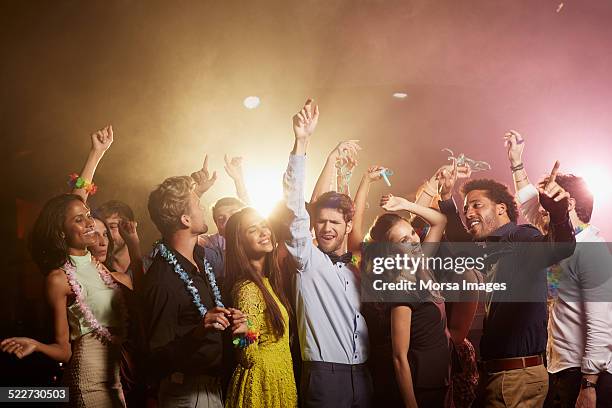 happy friends enjoying at nightclub - rave party photos et images de collection