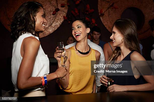 cheerful friends enjoying champagne in nightclub - wine party ストックフォトと画像