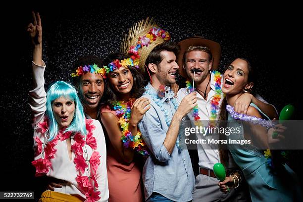 excited friends wearing garlands in nightclub - black hair wig stock pictures, royalty-free photos & images