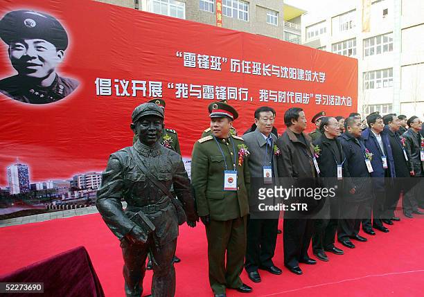 Chinese People's Liberation Army officer admires the statue of Lei Feng -- a baby-faced, selfless and frugal Communist Party soldier who lived at the...