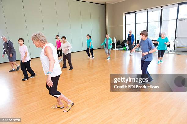 large group of seniors take line dancing class - line dancing stock pictures, royalty-free photos & images