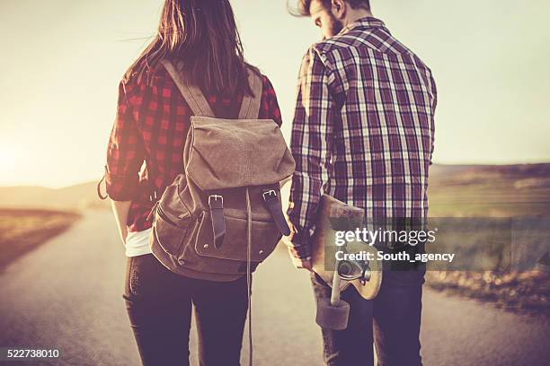 hipster couple standing on the road - plaid shirt stock pictures, royalty-free photos & images