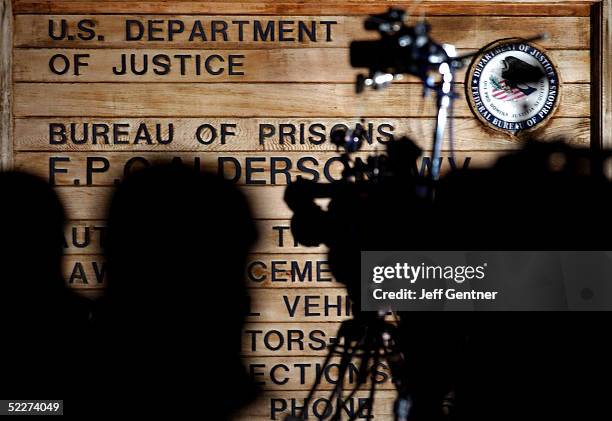 Members of the media wait outside the entrance to the Alderson Federal Prison Camp just before midnight March 3, 2005 in Alderson, West Virginia....