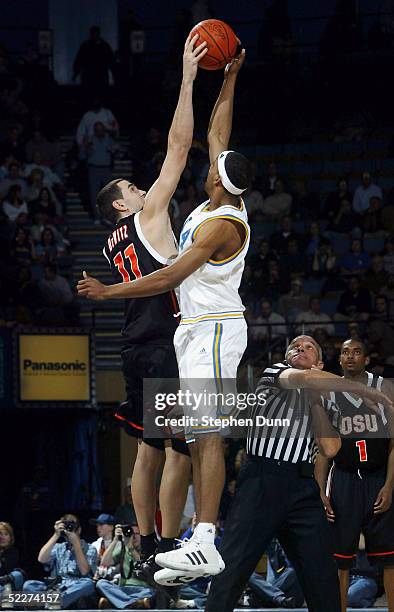 Dijon Thompson of the UCLA Bruins and NIck DeWitz of the Oregon State Beavers jump for the opening tipoff on March 3, 2005 at Pauley Pavillion in Los...