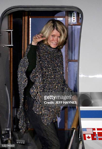Martha Stewart waves as she boards a chartered plane at the Greenbrier Valley Airport in Lewisburg, West Virginia 04 March, 2005 after her release...