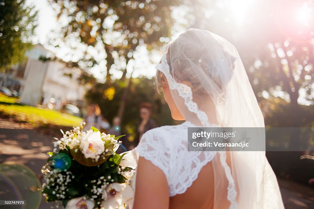 Beautiful bride holding flower bouquet