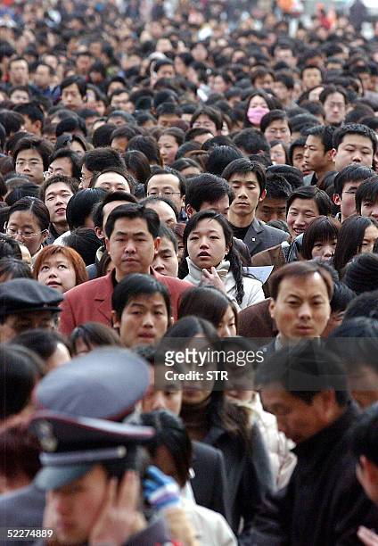 Thousands of job-hunters flock to a job fair in Xian 04 March 2005. China's urban population will reach 1.1 billion people by 2050 if the nation can...