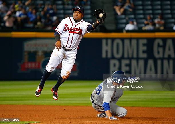 Chase Utley of the Los Angeles Dodgers steals second base under Erick Aybar of the Atlanta Braves in the 10th inning at Turner Field on April 20,...