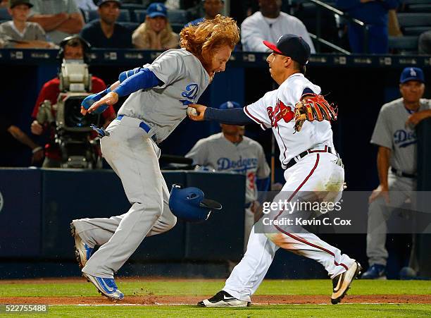 Justin Turner of the Los Angeles Dodgers was tagged out in a rundown by Daniel Castro of the Atlanta Braves down the third base line in the 10th...