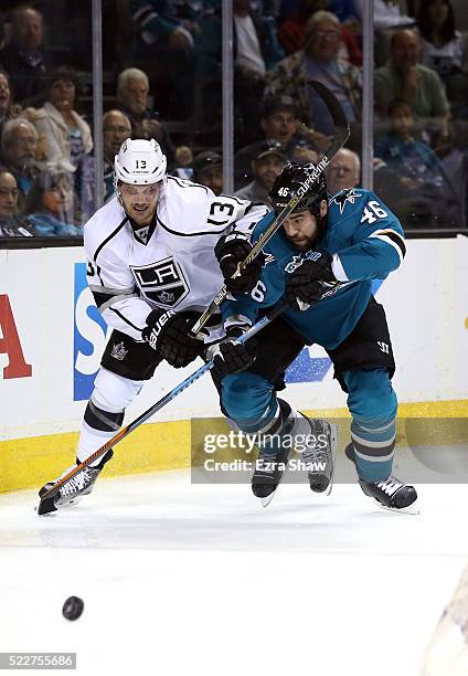 Kyle Clifford of the Los Angeles Kings and Roman Polak of the San Jose Sharks go for the puck in Game Four of the Western Conference First Round...