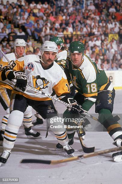 Canadian hockey player Bryan Trottier of the Pittsburgh Penguins battles with Bobby Smith of the Minnesota North Stars during the Stanley Cup finals...