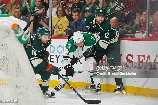 Justin Fontaine and David Jones of the Minnesota Wild battle for the puck with Mattias Janmark of the Dallas Stars in Game Four of the Western...