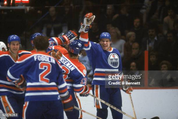 Canadian hockey player Mark Messier of the Edmonton Oilers and his teammates celebrate during a game against the Philadelphia Flyers at the Spectrum,...