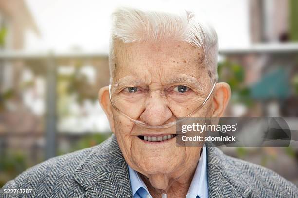 handsome 90 year old man outdoors wearing oxygen - medical oxygen equipment stock pictures, royalty-free photos & images