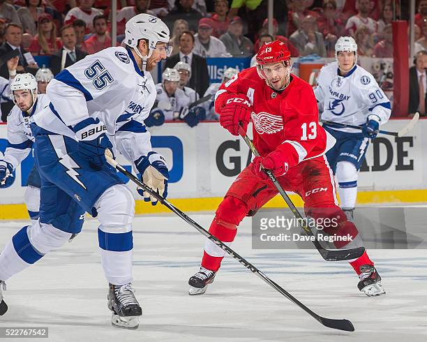 Pavel Datsyuk of the Detroit Red Wings passes the puck over the stick of Braydon Coburn of the Tampa Bay Lightning during Game Three of the Eastern...