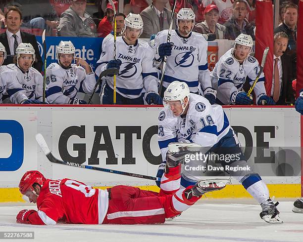 Ondrej Palat of the Tampa Bay Lightning trips up Justin Abdelkader of the Detroit Red Wings during Game Three of the Eastern Conference Quarterfinals...