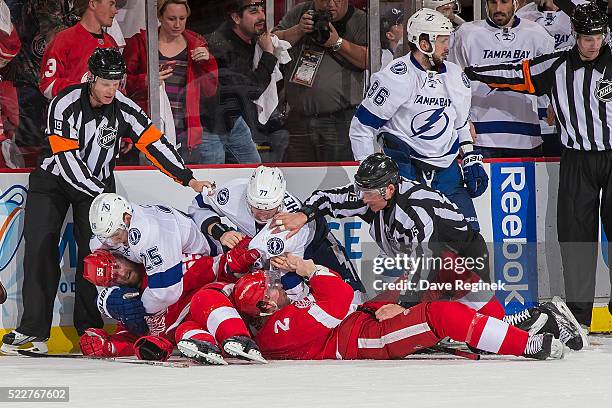 Referee Gord Dwyer and linesman Derek Amell try to break up a scrum between Niklas Kronwall and Brendan Smith of the Detroit Red Wings and Matt Carle...