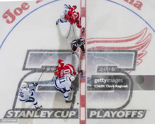 Henrik Zetterberg of the Detroit Red Wings faces off against Brian Boyle of the Tampa Bay Lightning as Gustav Nyquist of the Wings battles with Erik...