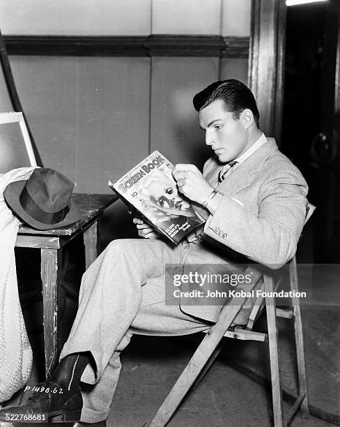 Portrait of actor and athlete Buster Crabbe reading a magazine, for Paramount Pictures, 1933.