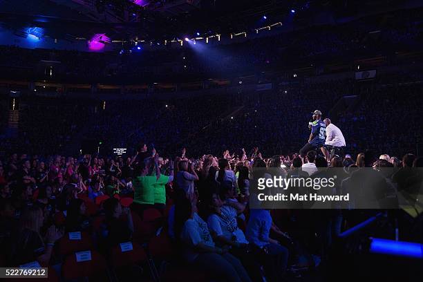 Radio Host Gee Scott and Seattle Seahawks Wide Receiver Ricardo Lockette speak on stage during We Day at KeyArena on April 20, 2016 in Seattle,...