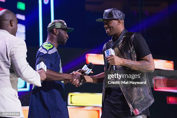 Seattle Seahawks Wide Receiver Ricardo Lockette and Kardinal Offishall shake hands on stage during We day at KeyArena on April 20, 2016 in Seattle,...