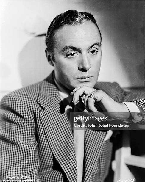 Portrait of actor Charles Boyer wearing a check jacket, for Paramount Pictures, 1933.