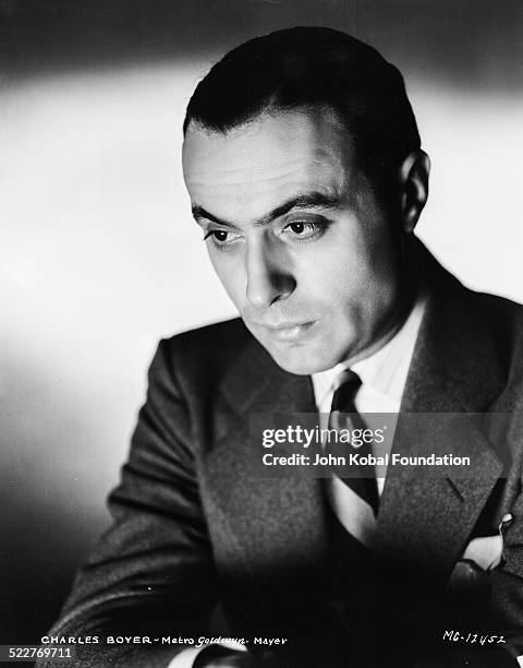 Headshot of actor Charles Boyer wearing a suit and tie, for MGM Studios, 1931.