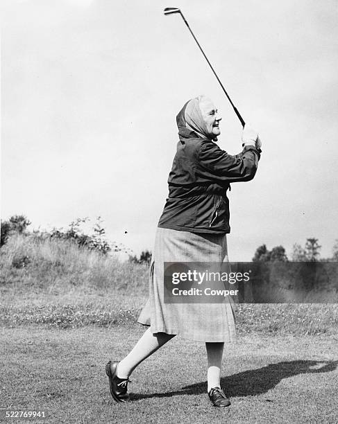 Lady Dorothy Macmillan, wife of British Prime Minister Harold Macmillan, swinging a golf club on the 18th hole, during a visit to Gleneagles,...