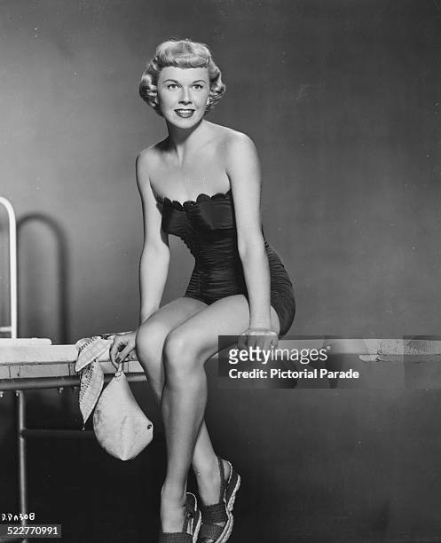 Portrait of singer and actress Doris Day wearing a swimsuit and sandals, as she appears in the movie 'The Winning Team', 1952.