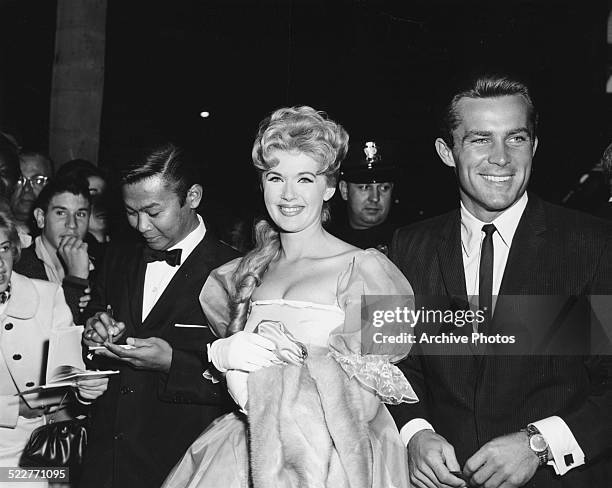 Actors Poncie Ponce, Connie Stevens and Robert Conrad, greeting fans as they arrive at the premiere of the movie 'Sunrise at Campobello', at the...