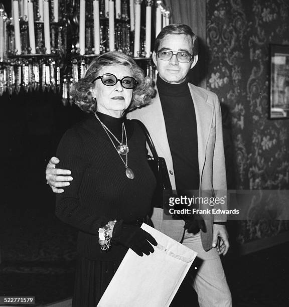 Actress Bette Davis, with her escort Ray Stricklyn, attending a press conference at the Beverly Hilton Hotel, California, March 1977.