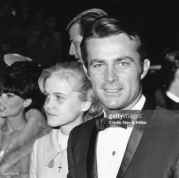 Actor Robert Conrad and his daughter Nancy, attending an event in formal dress, circa 1970.