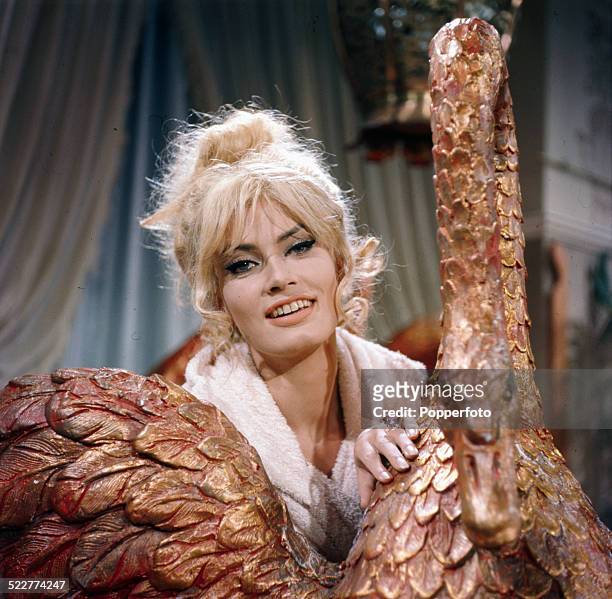 Austrian actress Marisa Mell posed next to a gold swan prop on the set of the Ken Russell film French Dressing in 1963.