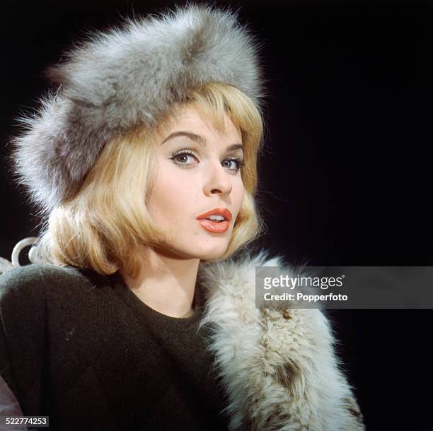 Austrian actress Senta Berger posed wearing a fur coat and hat on the set of the film 'The Victors' in 1963.
