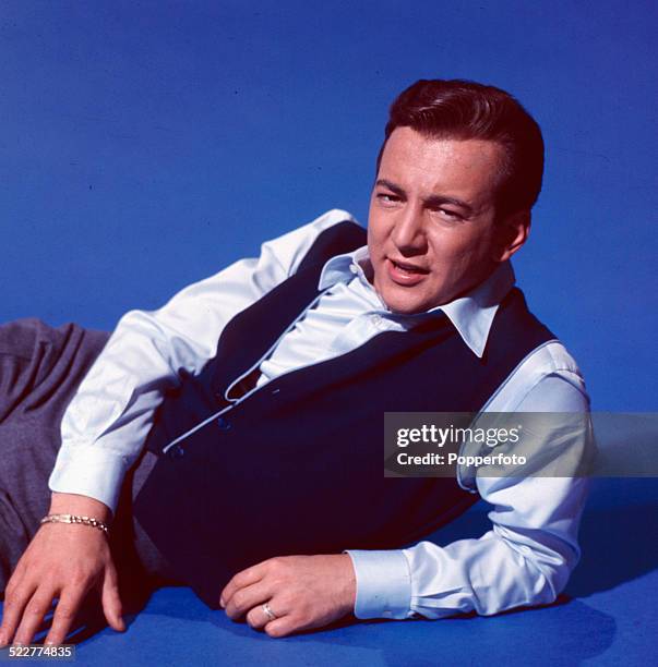 American singer Bobby Darin posed wearing a blue satin shirt and waistcoat in 1963.