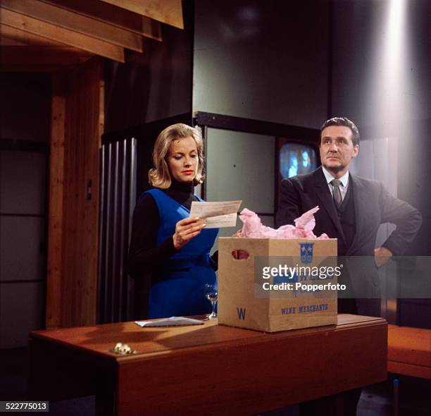English actress Honor Blackman and English actor Patrick Macnee pictured together in character as Cathy Gale and John Steed in a scene from the...