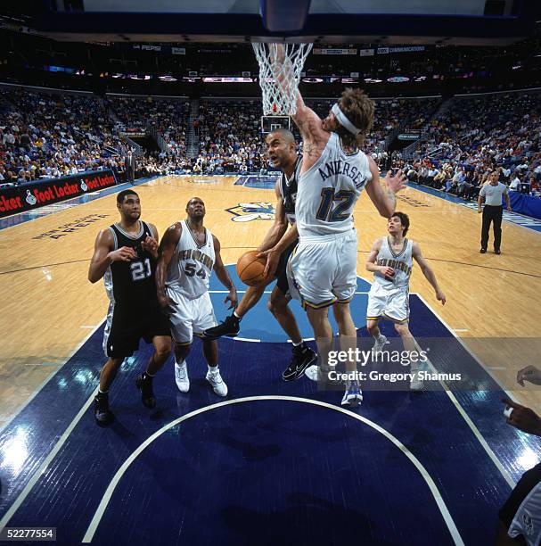 Tony Parker of the San Antonio Spurs drives to the basket against Chris Andersen of the New Orleans Hornets during the game at New Orleans Arena on...