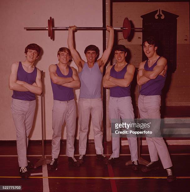 English pop group The Dave Clark Five posed at the YMCA gymnasium in London in 1964. From left to right: Rick Huxley, Lenny Davidson, Dave Clark,...