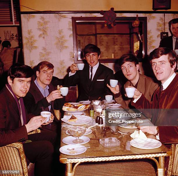 English pop group The Dave Clark Five posed together in a cafe in London in 1964. From left to right: Denis Payton, Lenny Davidson, Dave Clark, Mike...