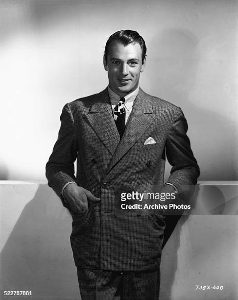 Portrait of actor Gary Cooper, wearing a double breasted suit, tie and pocket square, circa 1940.