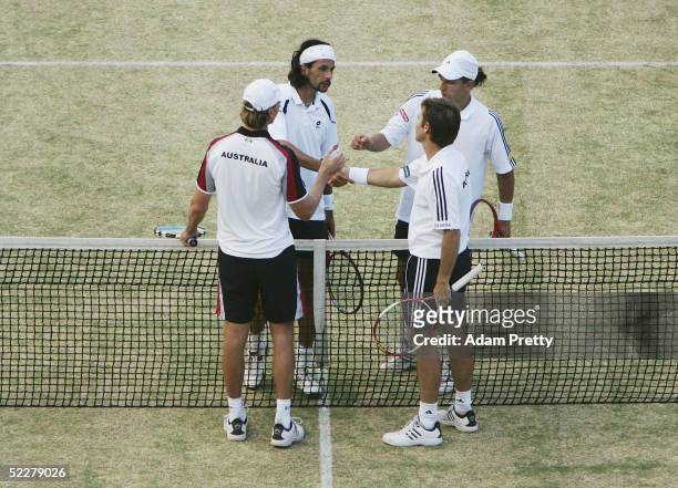 Todd Woodbridge and Wayne Arthurs of Australia are congratulated by Jurgen Melzer and Julian Knowle of Austria during the third rubber of the Davis...