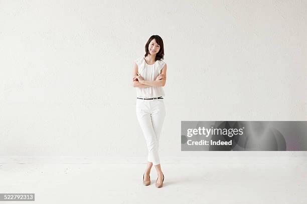 a woman who makes a pose - white pants foto e immagini stock