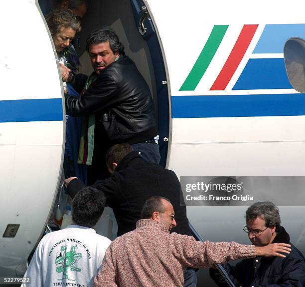 Freed Italian hostage Giuliana Sgrena is helped out of the plane at Ciampino airport a day after she was rescued from her Iraqi kidnappers March 5,...