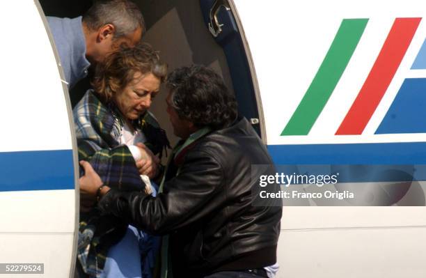 Freed Italian hostage Giuliana Sgrena is helped out of the plane at Ciampino airport a day after she was rescued from her Iraqi kidnappers March 5,...