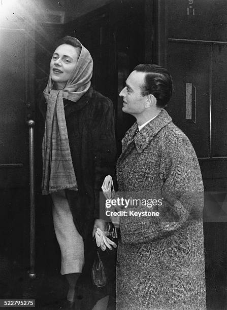 Actress Celia Johnson and director David Lean boarding a train at Victoria Station, on their way to Paris to promote their film 'Brief Encounter',...