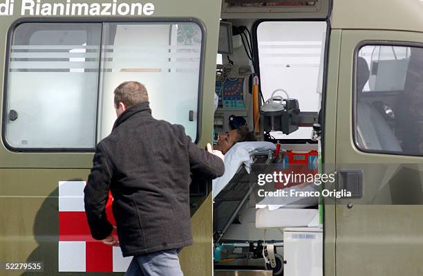 Freed Italian hostage Giuliana Sgrena is escorted to an ambulance on a stretcher at Ciampino airport a day after she was rescued from her Iraqi...